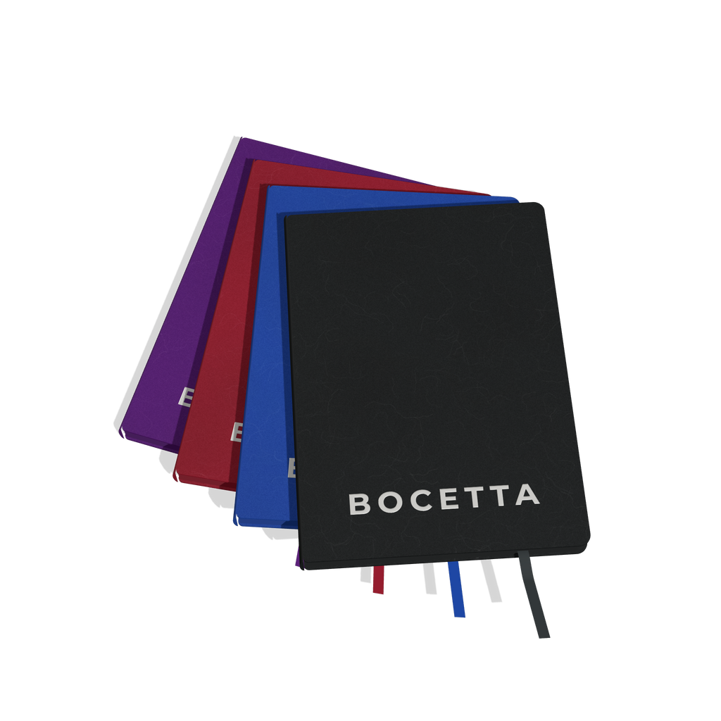 Bocetta notebooks in black, blue, red and purple, fanned out: monochrome journals with matching colored pages